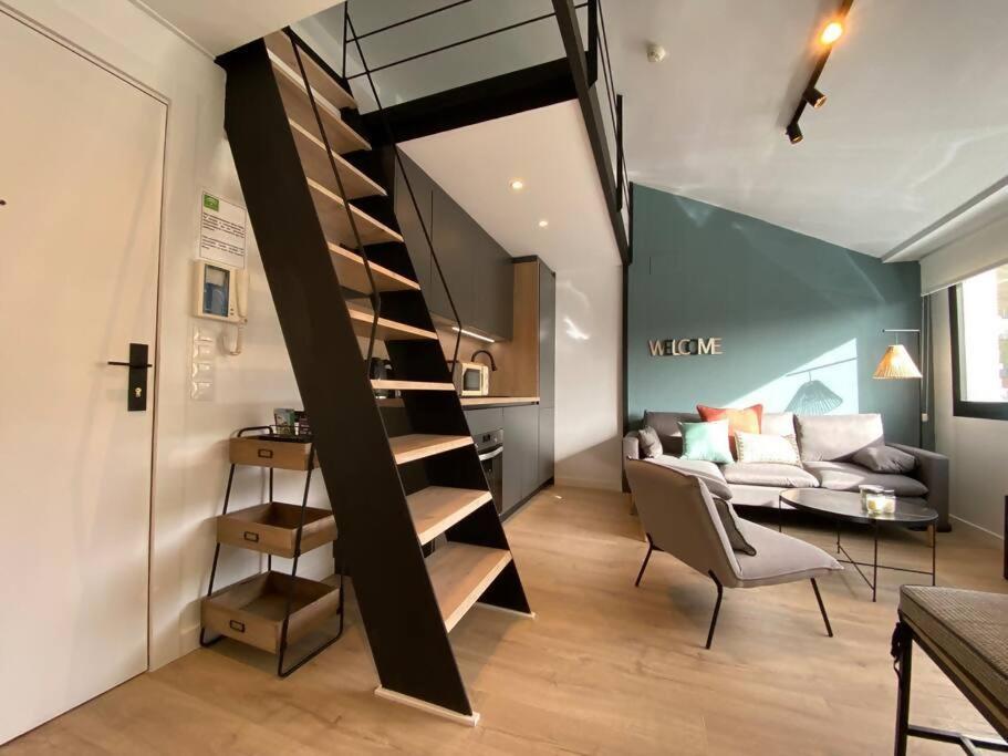 a living room with a spiral staircase and a couch at Skade Sierra Nevada Zona Baja in Sierra Nevada