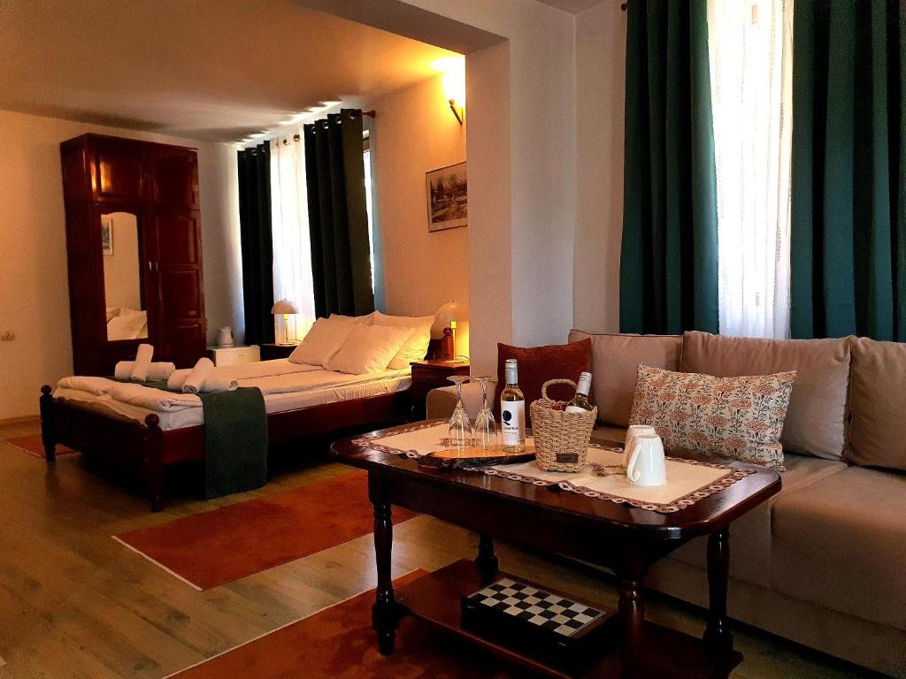 a living room with a couch and a table at Dvata Smurcha Central Apartments - Free Parking in Bansko