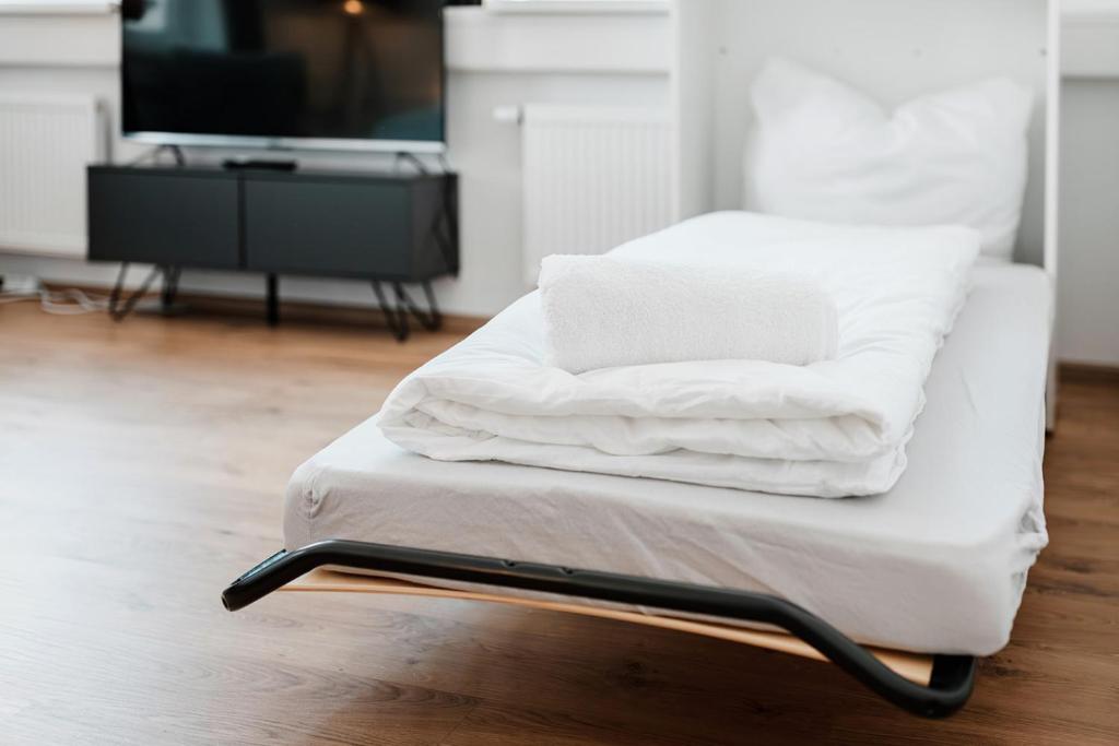 Postel nebo postele na pokoji v ubytování Shared-LiveWork Suites