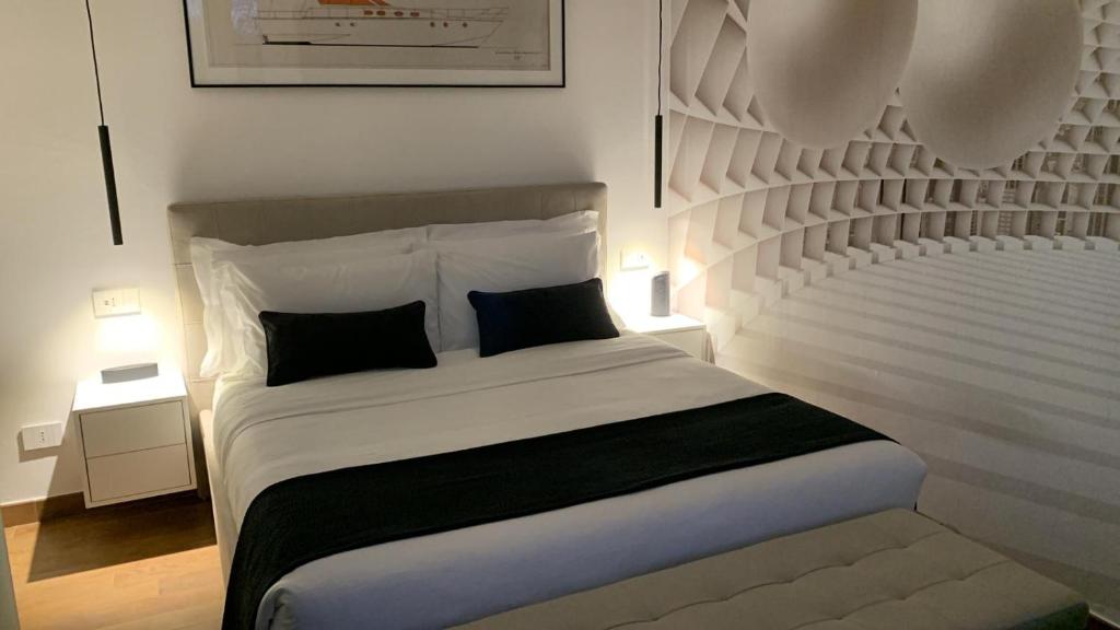 a bedroom with a large white bed with two pillows at Rossodisera in Sarzana
