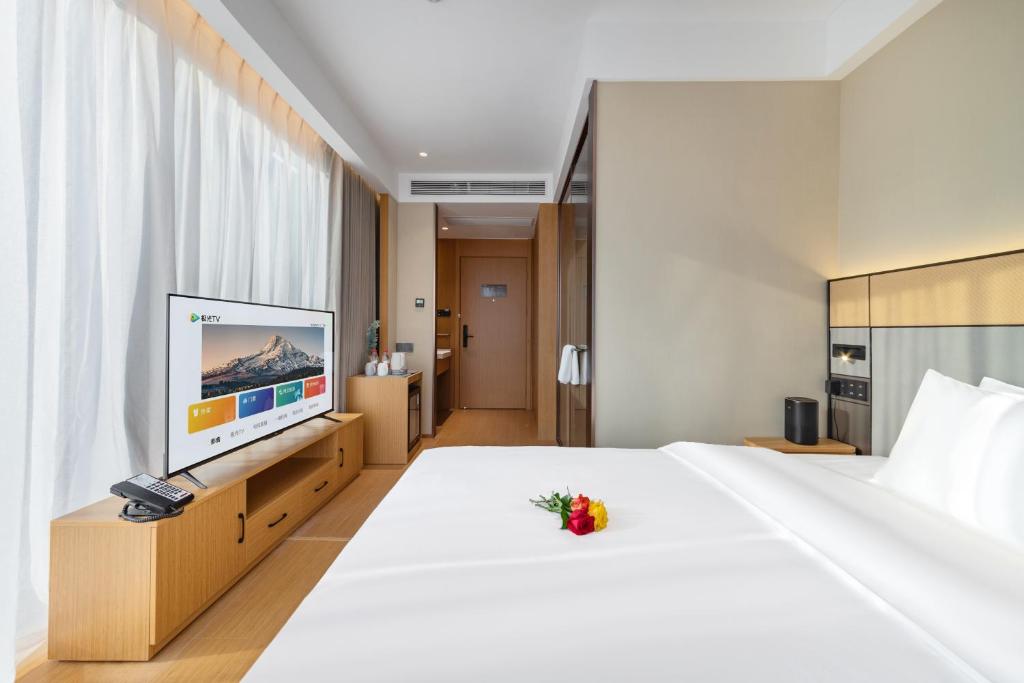 Postel nebo postele na pokoji v ubytování Yibo Hotel - Pazhou Convention and Exhibition Center - Walking distance to Canton Fair