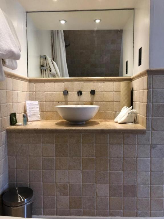a bathroom with a sink and a mirror at Langtry Manor Hotel in Bournemouth