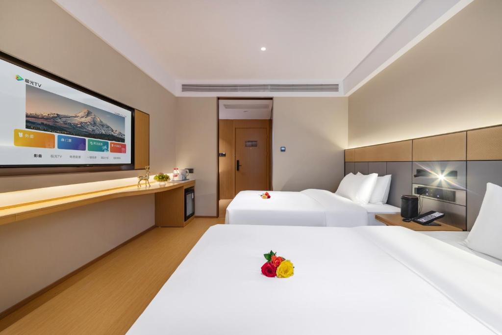 Postel nebo postele na pokoji v ubytování Yibo Hotel - Pazhou Convention and Exhibition Center - Walking distance to Canton Fair
