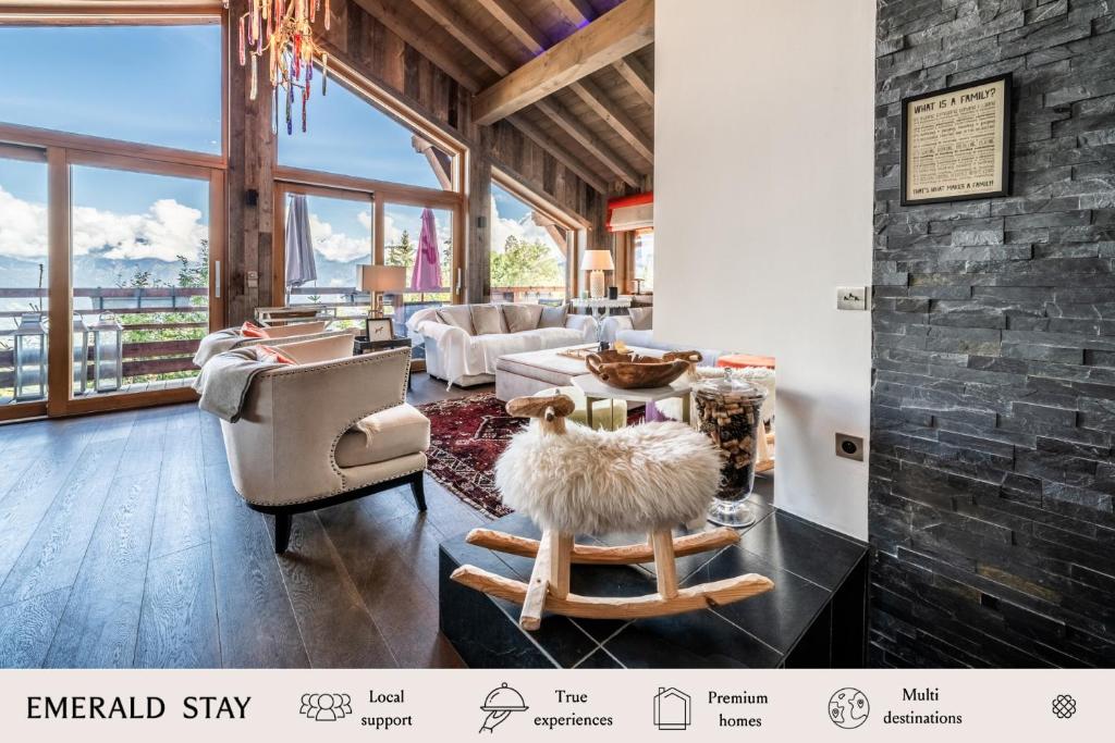 a living room with a stone wall and furniture at Chalet Purdey Combloux - BY EMERALD STAY in Combloux