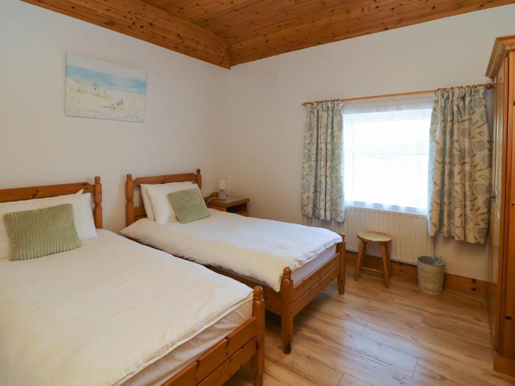 Postel nebo postele na pokoji v ubytování Rose Cottage