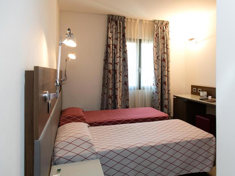 Postel nebo postele na pokoji v ubytování Hotel Del Parco