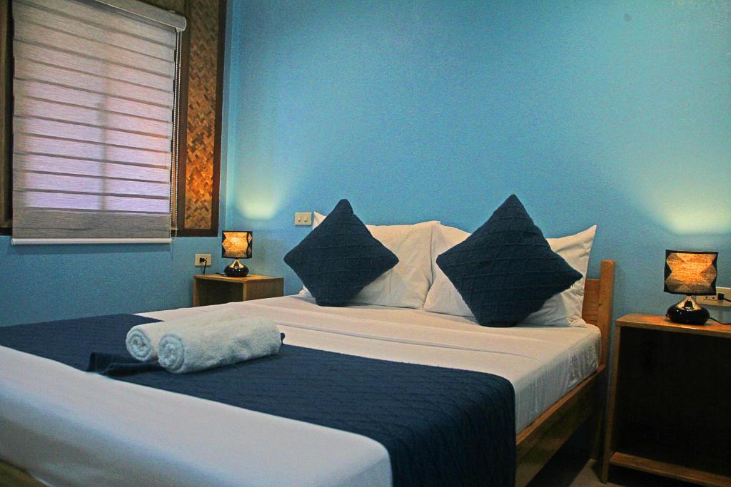 Postel nebo postele na pokoji v ubytování Hotel Oasis Port Barton