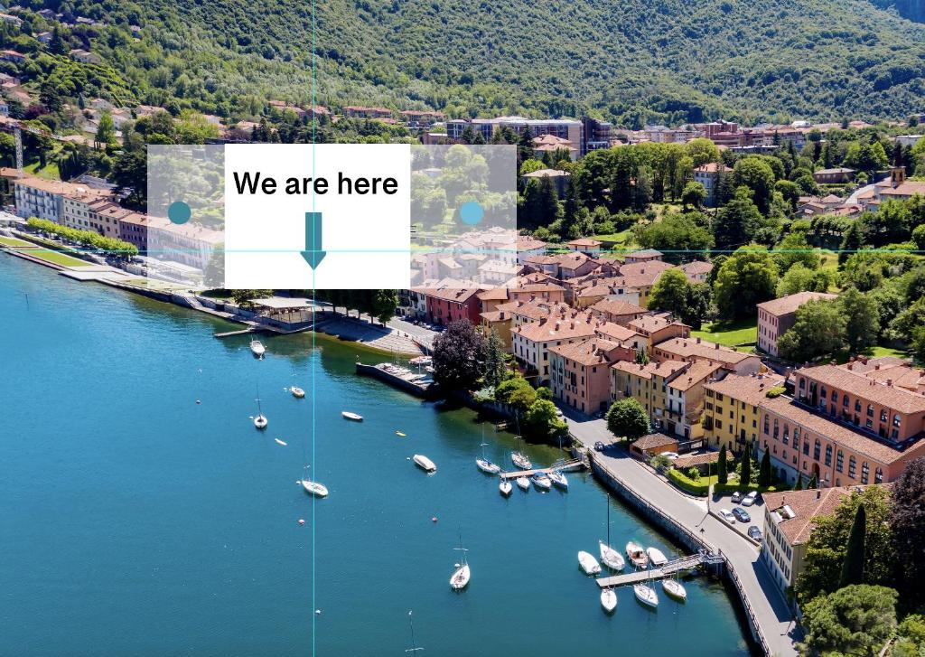 an aerial view of a town with boats in the water at La finestra sul lago in Malgrate
