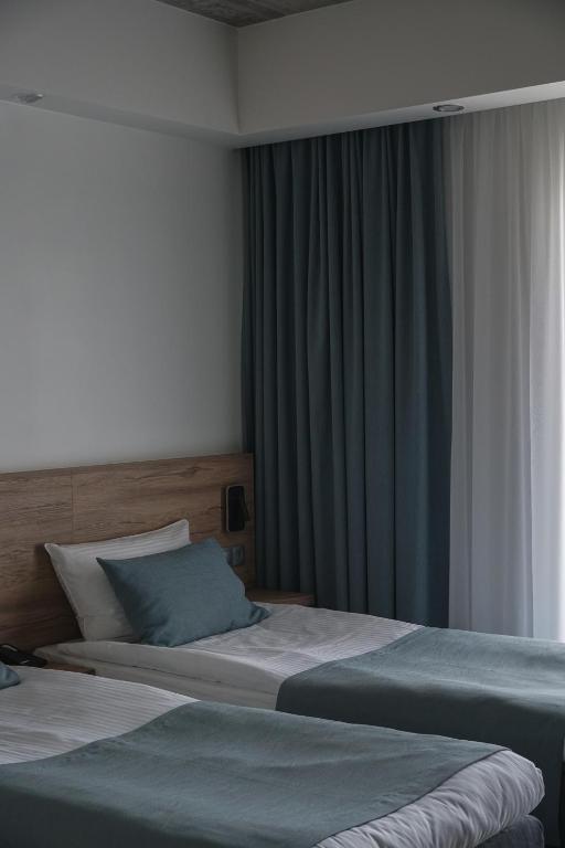 Postel nebo postele na pokoji v ubytování Molėtai Hotel