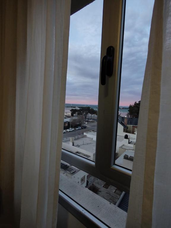 a view of a city from a window at Prismático in Puerto Madryn