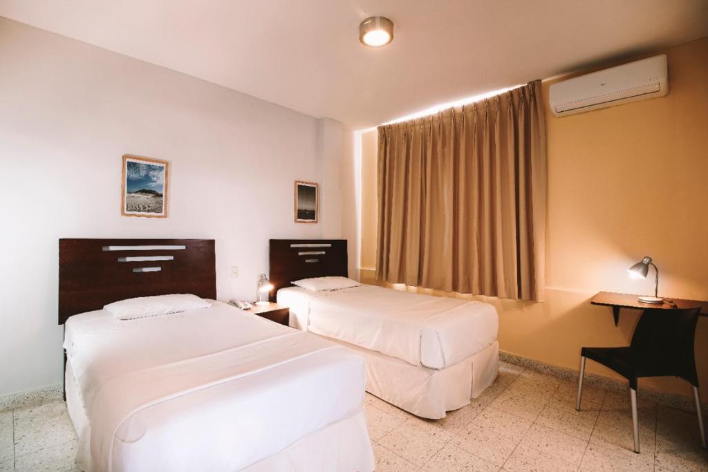 Postel nebo postele na pokoji v ubytování Hotel Oro Negro