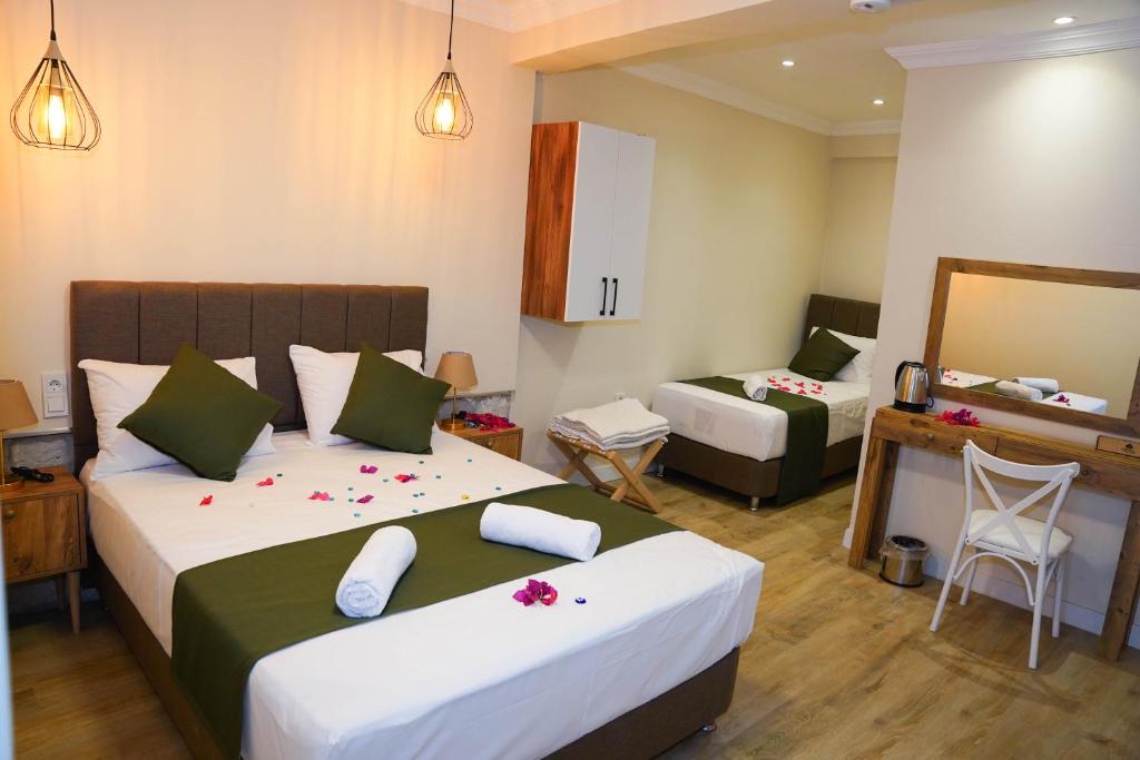 Postel nebo postele na pokoji v ubytování PRUVA İNN HoTEL