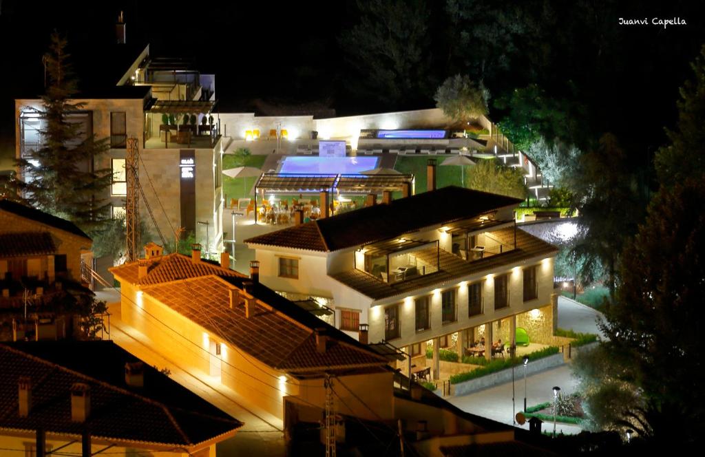a group of buildings at night with lights at Finca Los Olivos in Alcalá del Júcar