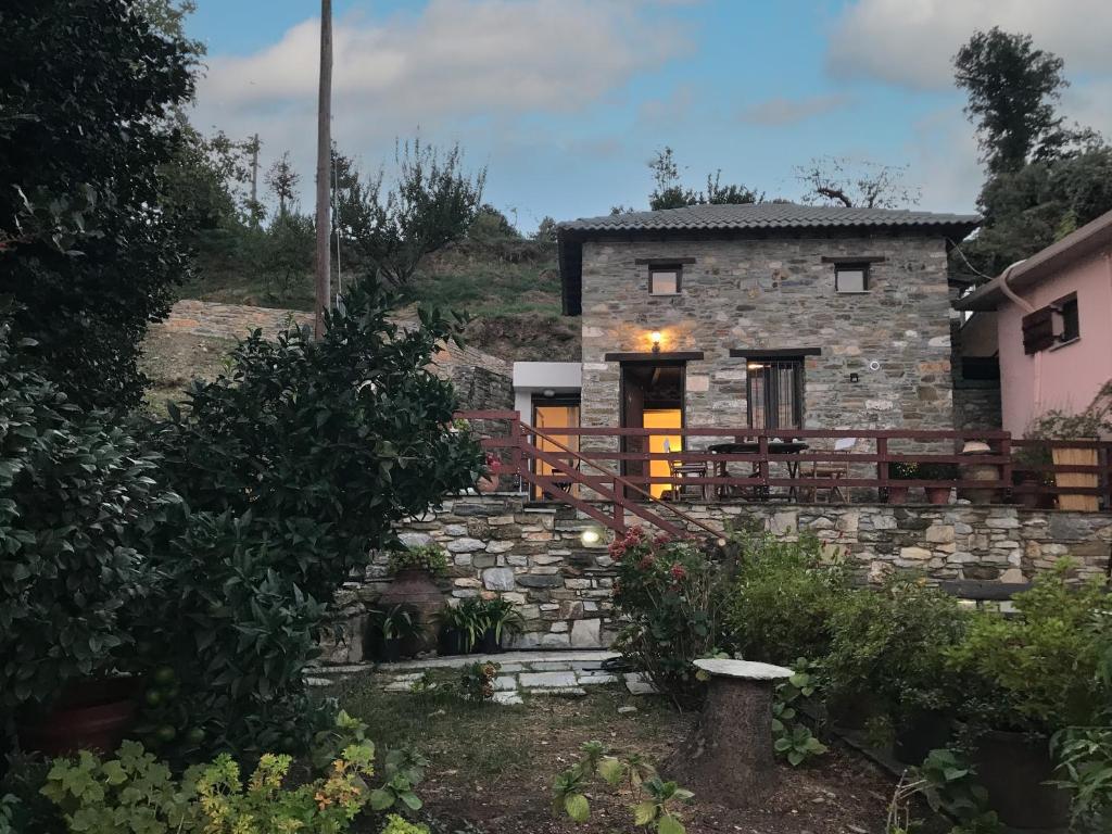a stone house with a staircase leading up to it at Sweet Stone Cottage in Tsagarada