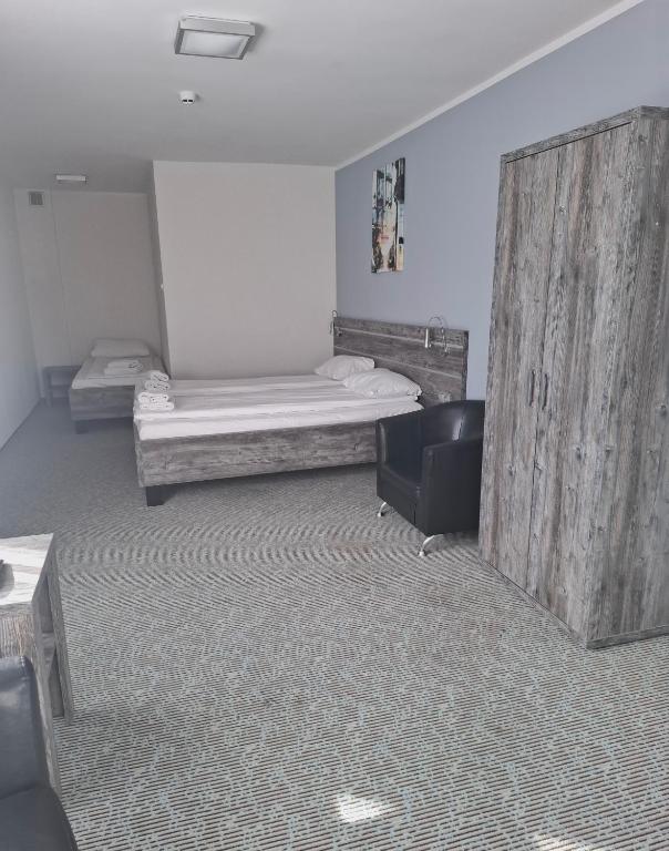Posteľ alebo postele v izbe v ubytovaní Hotel Giżycko