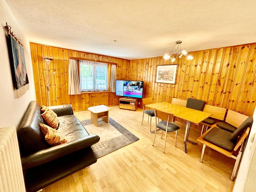 a living room with a couch and a table at Chalet Medi in Zermatt