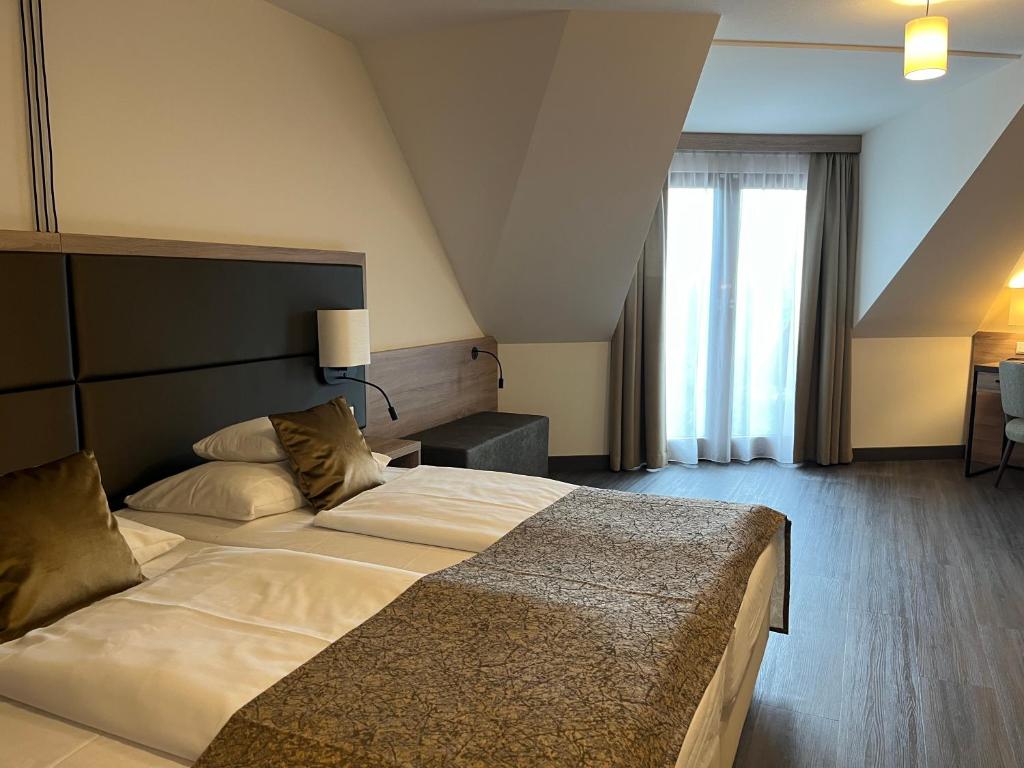 Postel nebo postele na pokoji v ubytování Flair Park Hotel Ilshofen