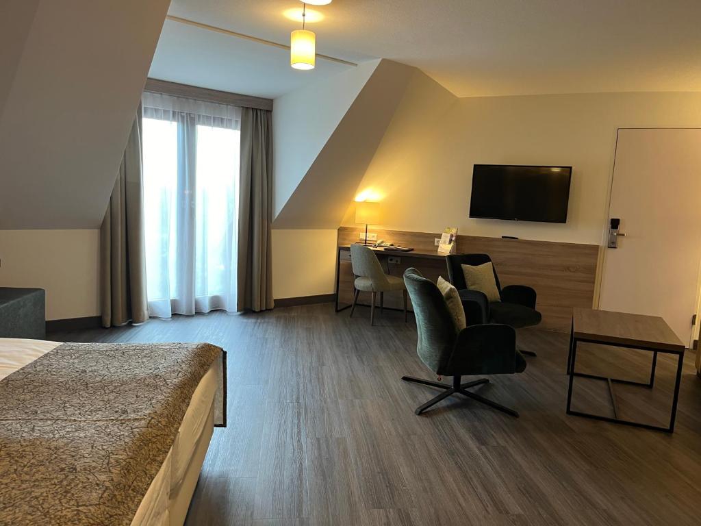 TV a/nebo společenská místnost v ubytování Flair Park Hotel Ilshofen