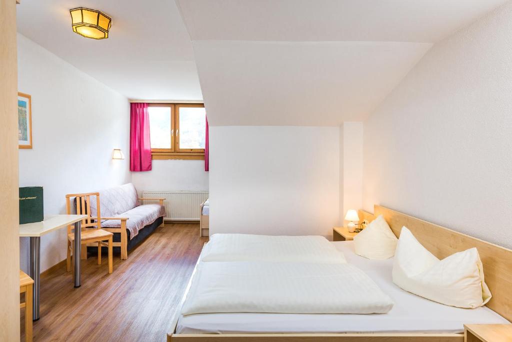 Postel nebo postele na pokoji v ubytování Hotel Grissemann