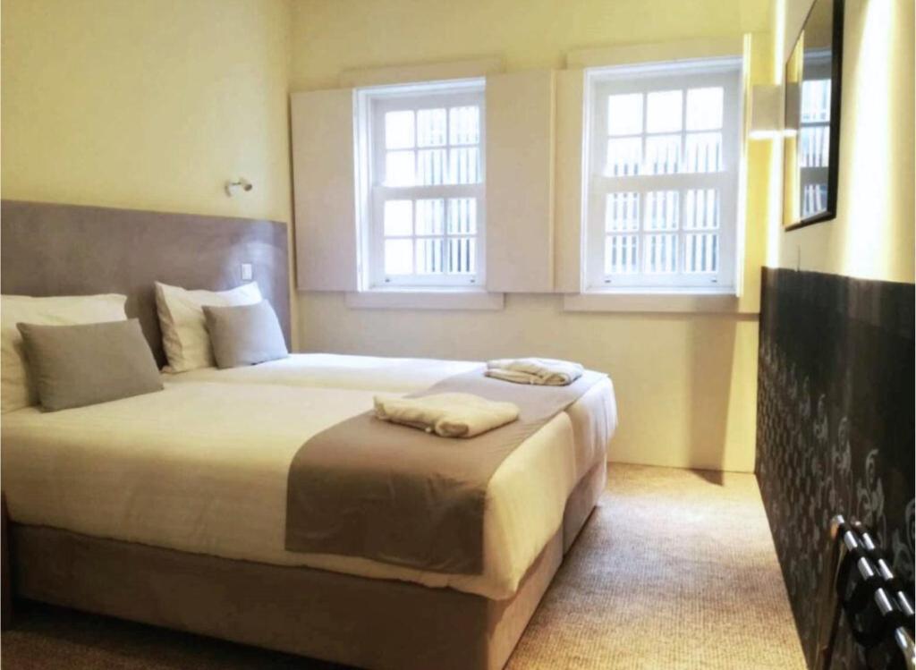 Postel nebo postele na pokoji v ubytování EMAJ Boutique Hotel