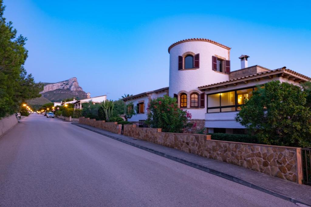 a house on the side of a street at night at Sa vinya in Colonia de Sant Pere