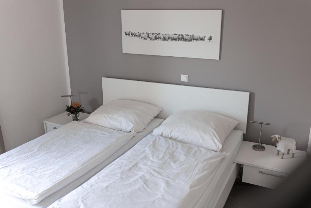 Postel nebo postele na pokoji v ubytování watn Meerblick-Nordseepark Dangast, 2Schlafzimmer,2Bäder,Kamin,Parkplatz