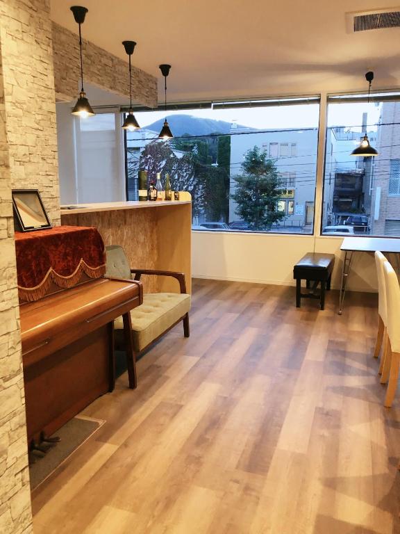 a living room with a bench and a table at Little Garden in Otaru