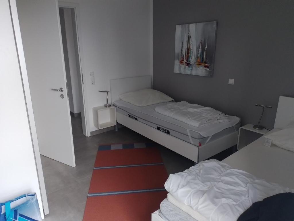 Postel nebo postele na pokoji v ubytování watn Meerblick-Nordseepark Dangast, 2Schlafzimmer,2Bäder,Kamin,Parkplatz