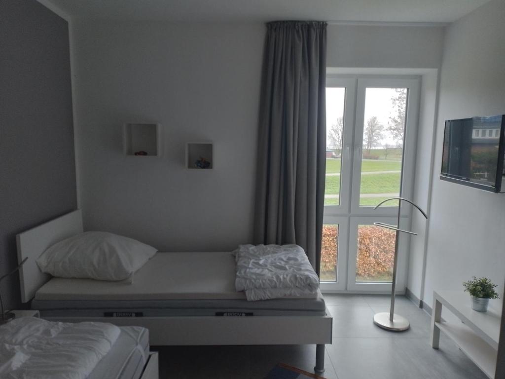 Postel nebo postele na pokoji v ubytování watn Meerblick-Nordseepark Dangast, 2Schlafzimmer,2Bäder,Kamin,Parkplatz