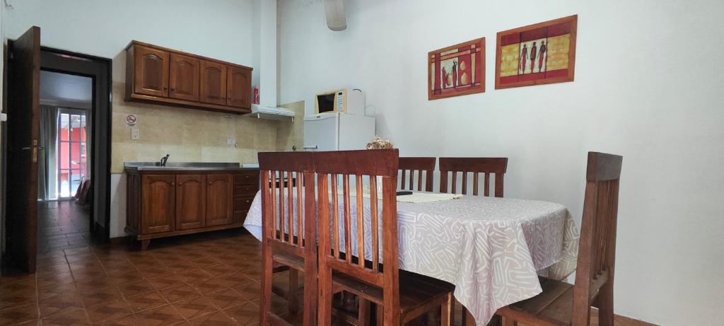 a kitchen with a table and a kitchen with a refrigerator at Departamento Bienestar Termas in Federación