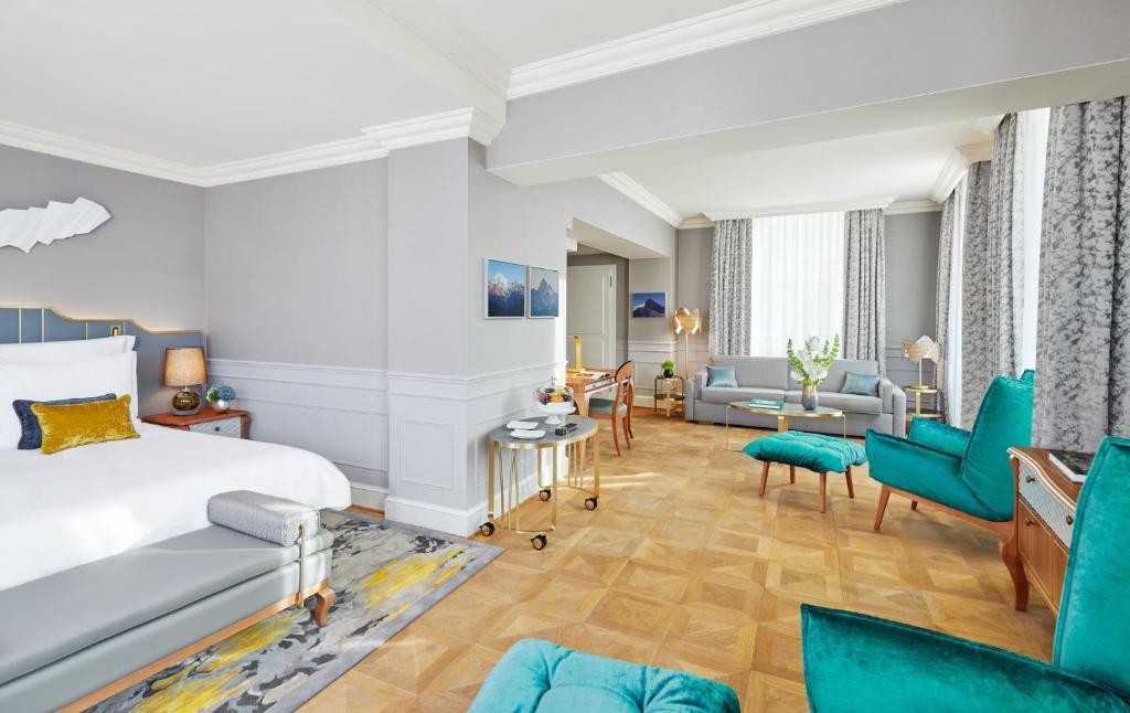 a bedroom with a bed and a living room at Mandarin Oriental, Munich in Munich