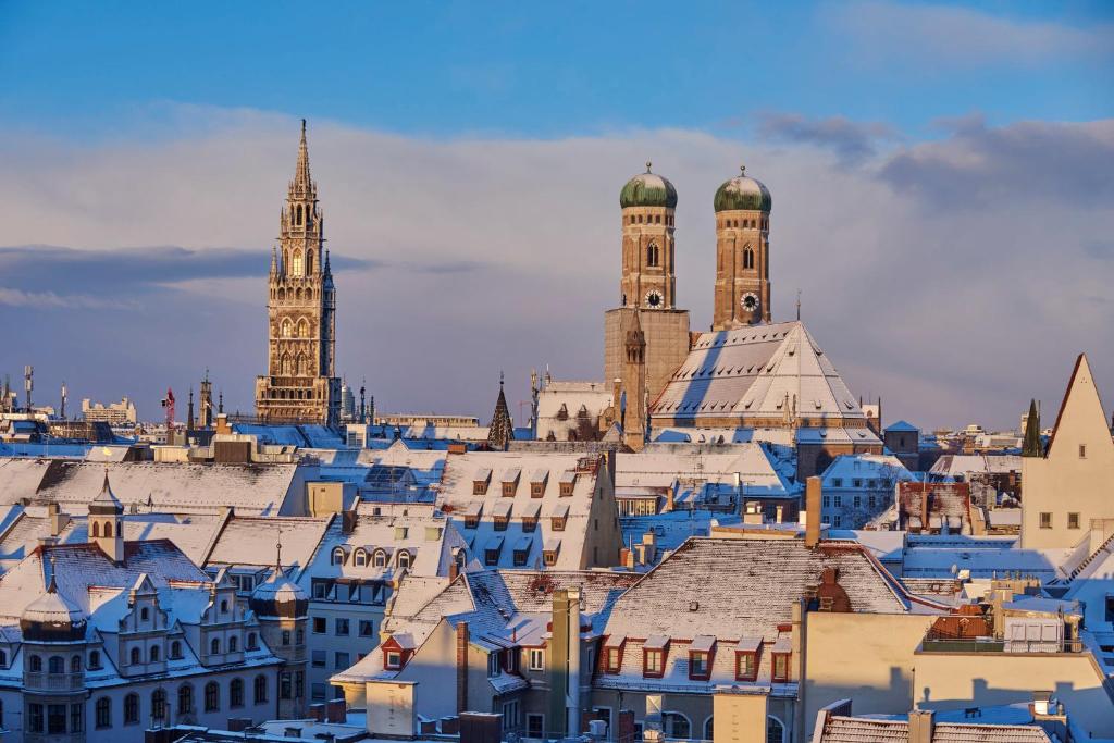 a view of the roofs of buildings in a city at Mandarin Oriental, Munich in Munich