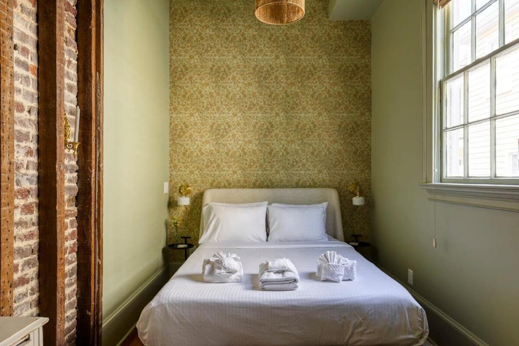 a bedroom with a bed with towels on it at Innkeepers Quarters Queen Suite with Breakfast in Charleston