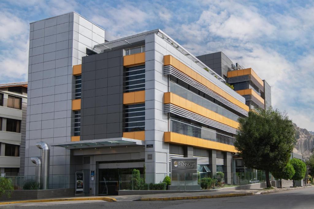 a large building with an office building at Hotel Rennova in La Paz