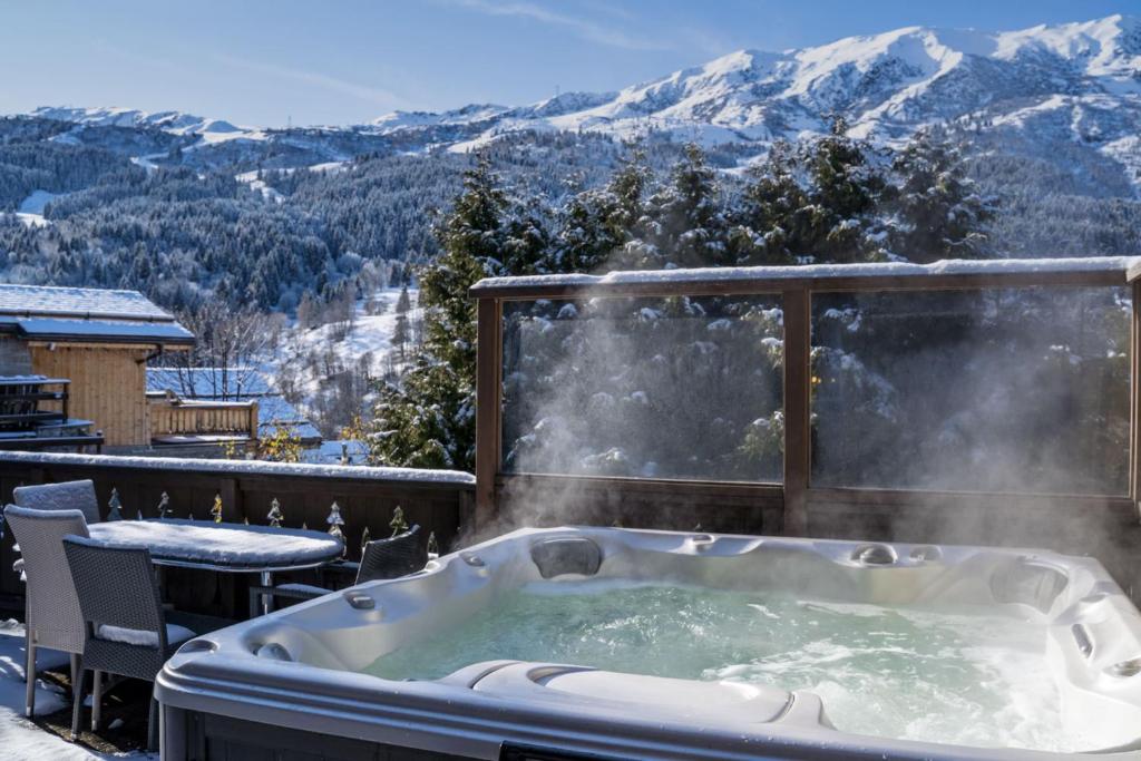 a jacuzzi tub on a balcony with mountains at Chalet Matterhorn in Mussillon