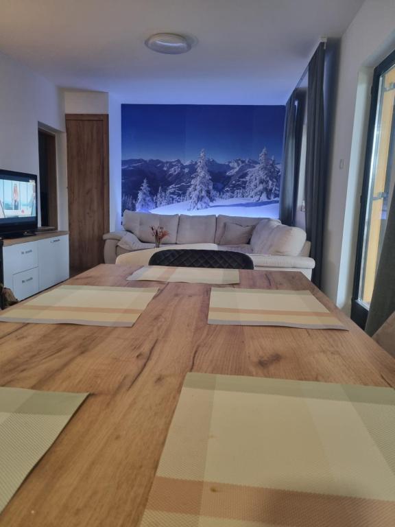 a living room with a couch and a television at Friends Vlašić in Vlasic