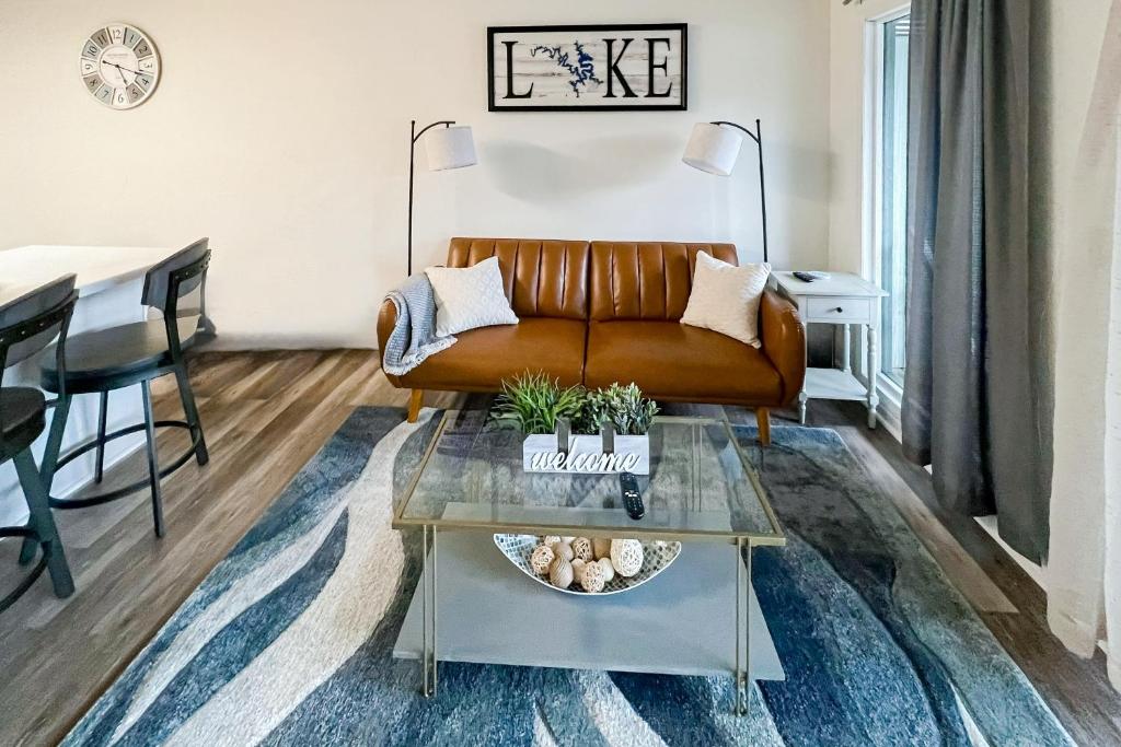 a living room with a couch and a table at The Luxe Lakefront in Lake Ozark