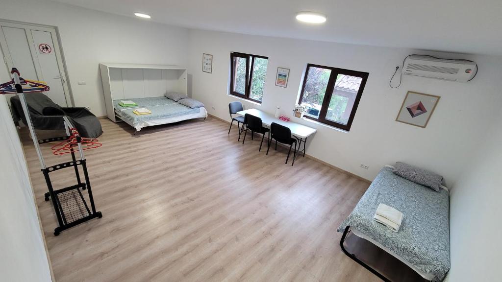 a living room with a couch and a table and chairs at Private Room - Terasa - Gradina in Paşcani