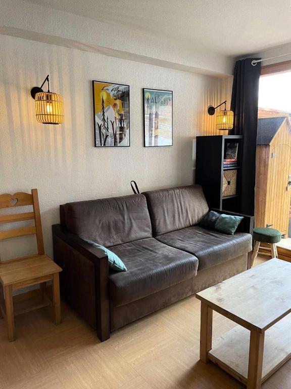 un salon avec un canapé en cuir et une table dans l'établissement Résidence Parc Des Airelles - APPARTEMENT PARC DES AIRELLES 110 MAE-7291, aux Orres