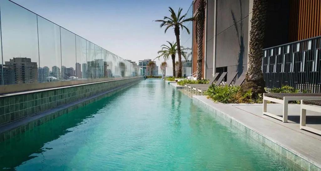 a river in a city with palm trees and buildings at Get a Flat 1905 - Brooklin in Sao Paulo