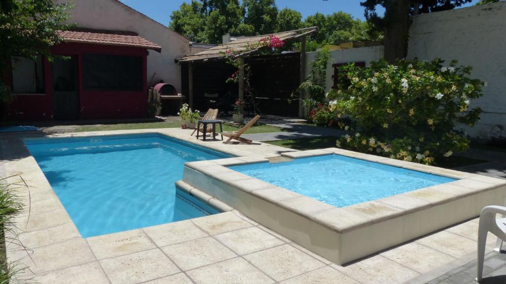 a swimming pool in a yard with a patio at Chill Inn Hostel in Mendoza