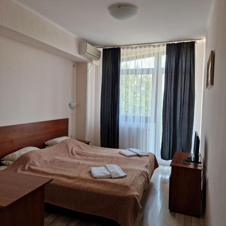 Postel nebo postele na pokoji v ubytování Hotel Helikon