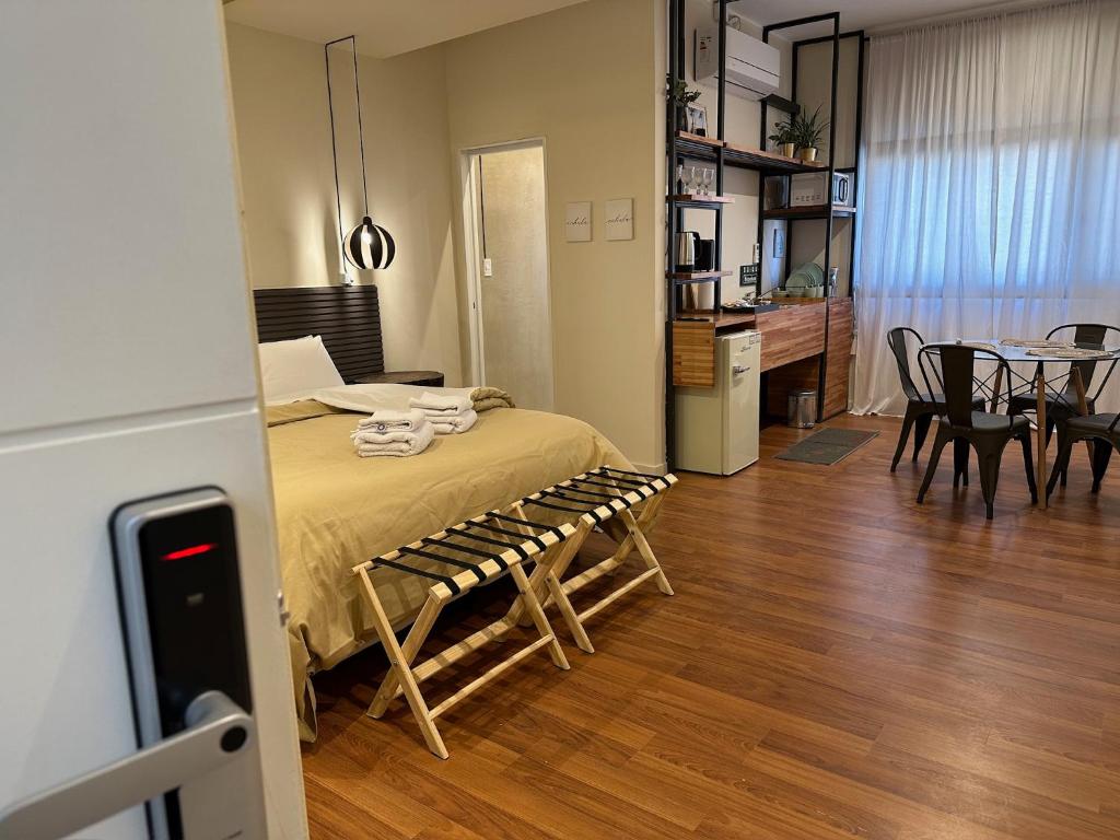 una habitación con una cama, una mesa y sillas en Hito Urbano, en Chilecito