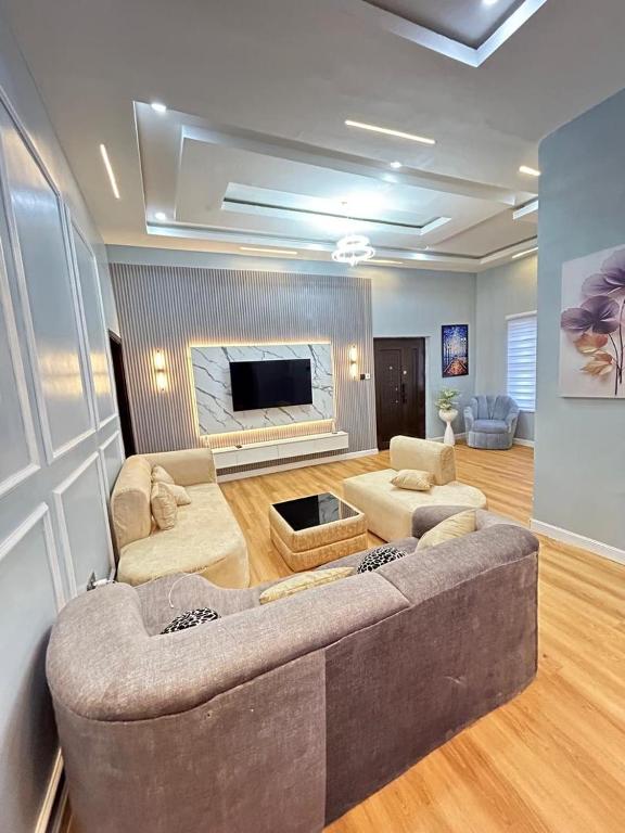 a living room with a large couch and a fireplace at Fortuna x Rina in Lagos