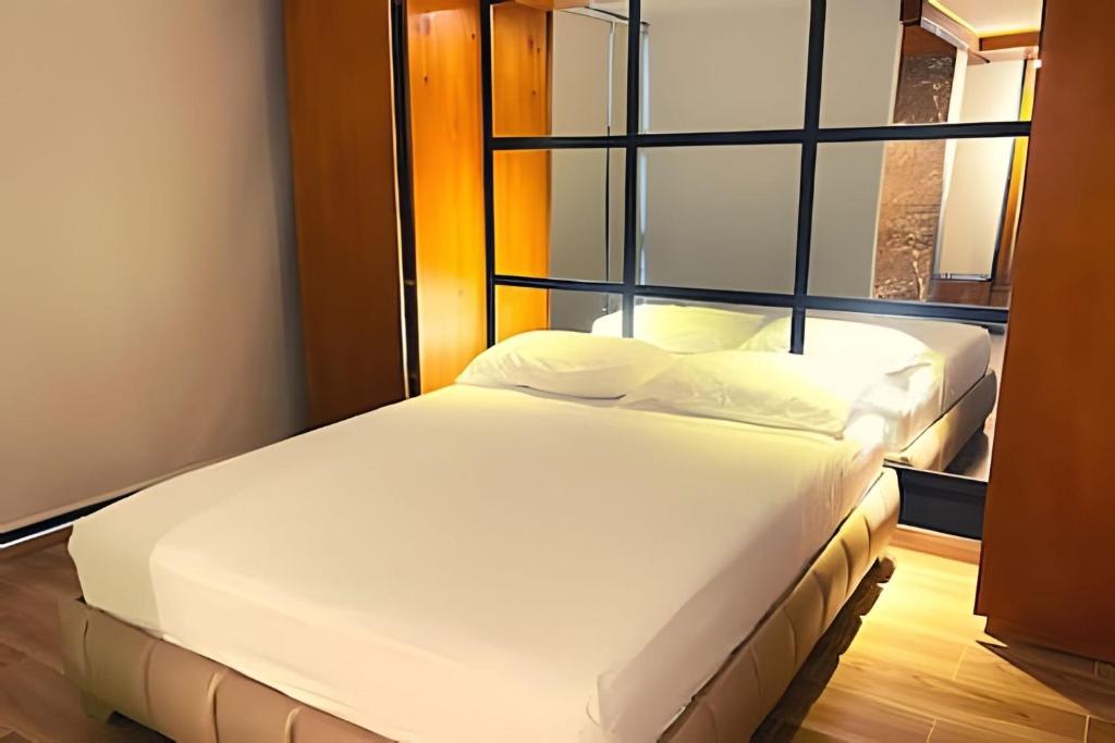 Postel nebo postele na pokoji v ubytování Apartaestudios Calle 76