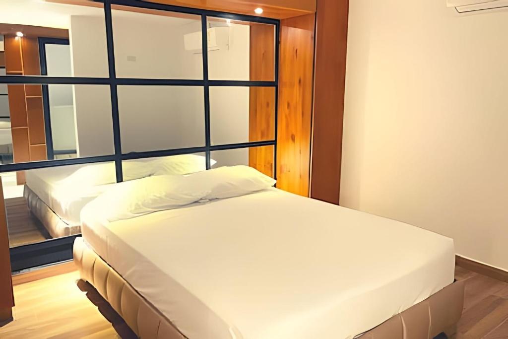 Postel nebo postele na pokoji v ubytování Apartaestudios Calle 76