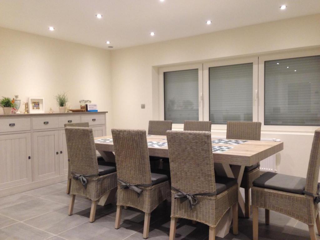 a dining room with a wooden table and chairs at Bruges Brujas holiday house in Bruges