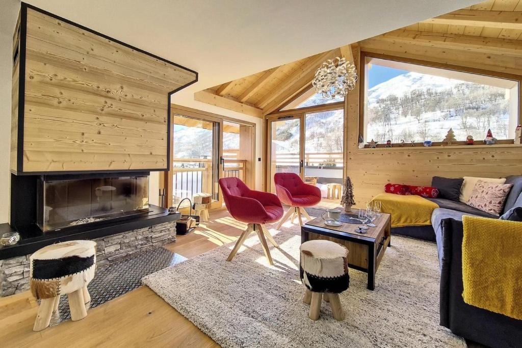 a living room with a couch and a fireplace at Résidence Le Bettex - Chalet Ydilia MAE-9624 in Praranger