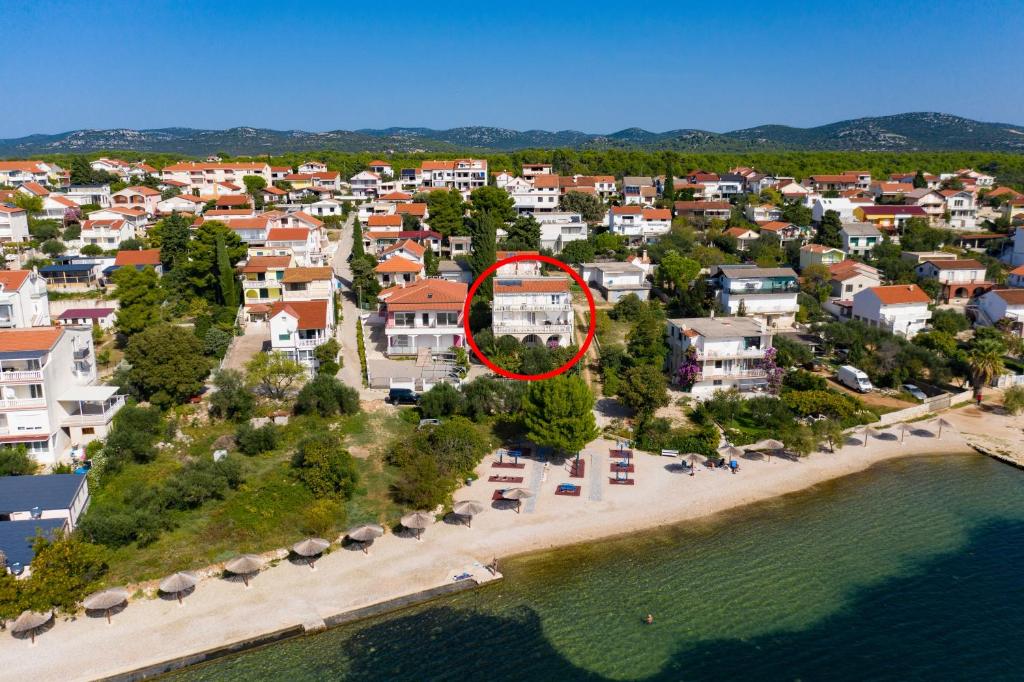 an aerial view of a house on a beach at Apartments by the sea Pirovac, Sibenik - 6447 in Pirovac