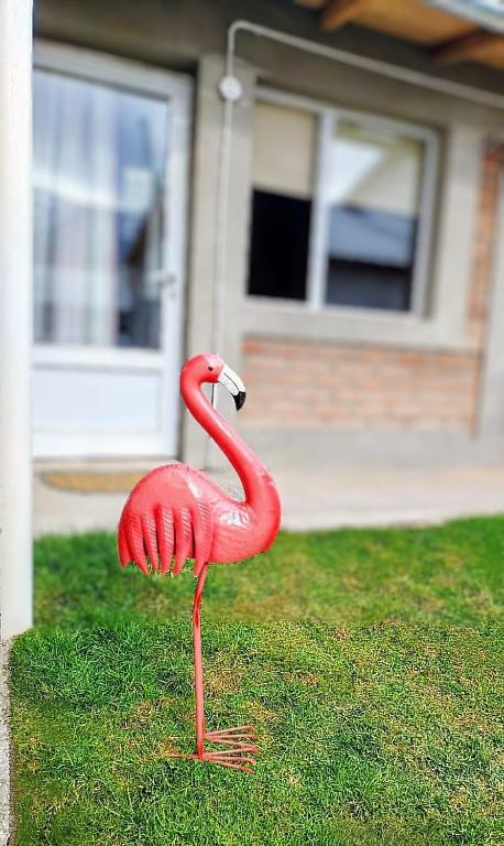 a red flamingo statue in front of a house at FLAMENCOS Apart in Esquel